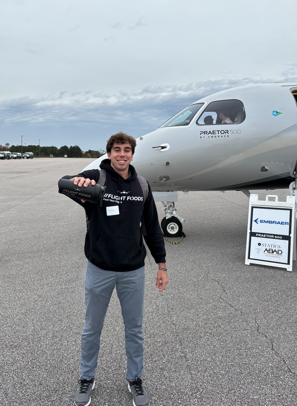 Thomas representing Flight Foods in front of a plane